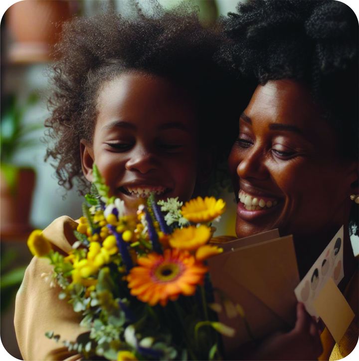 A mother and child laughing with a bouquet of flowers and a card