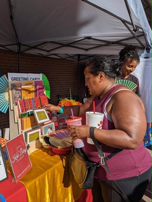 A shopper browsing the Kab Libey greeting card display