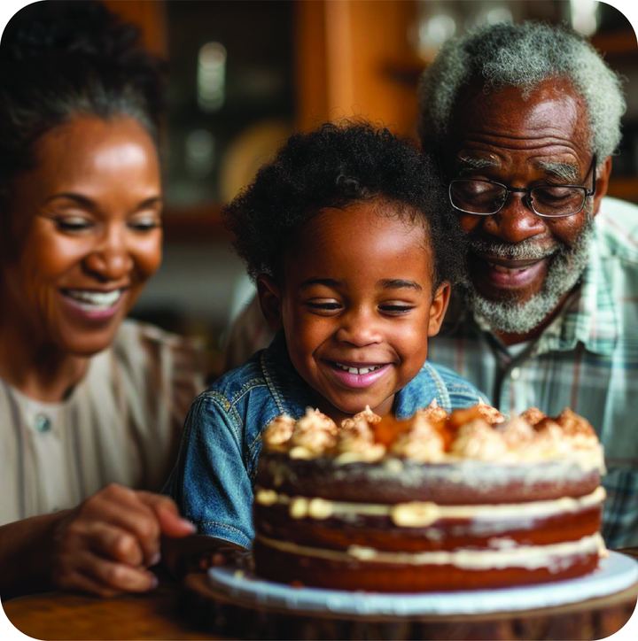 Grandparents and grandchild smiling over a birthday cake